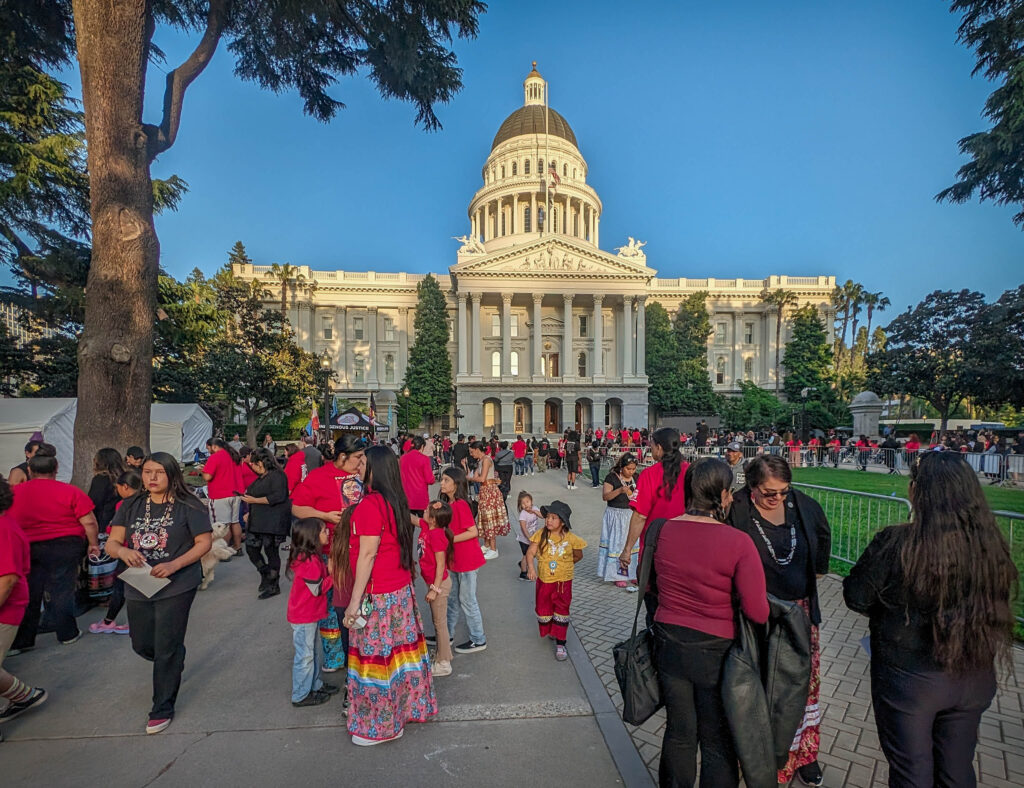 People dressed in red attending the vigil. 